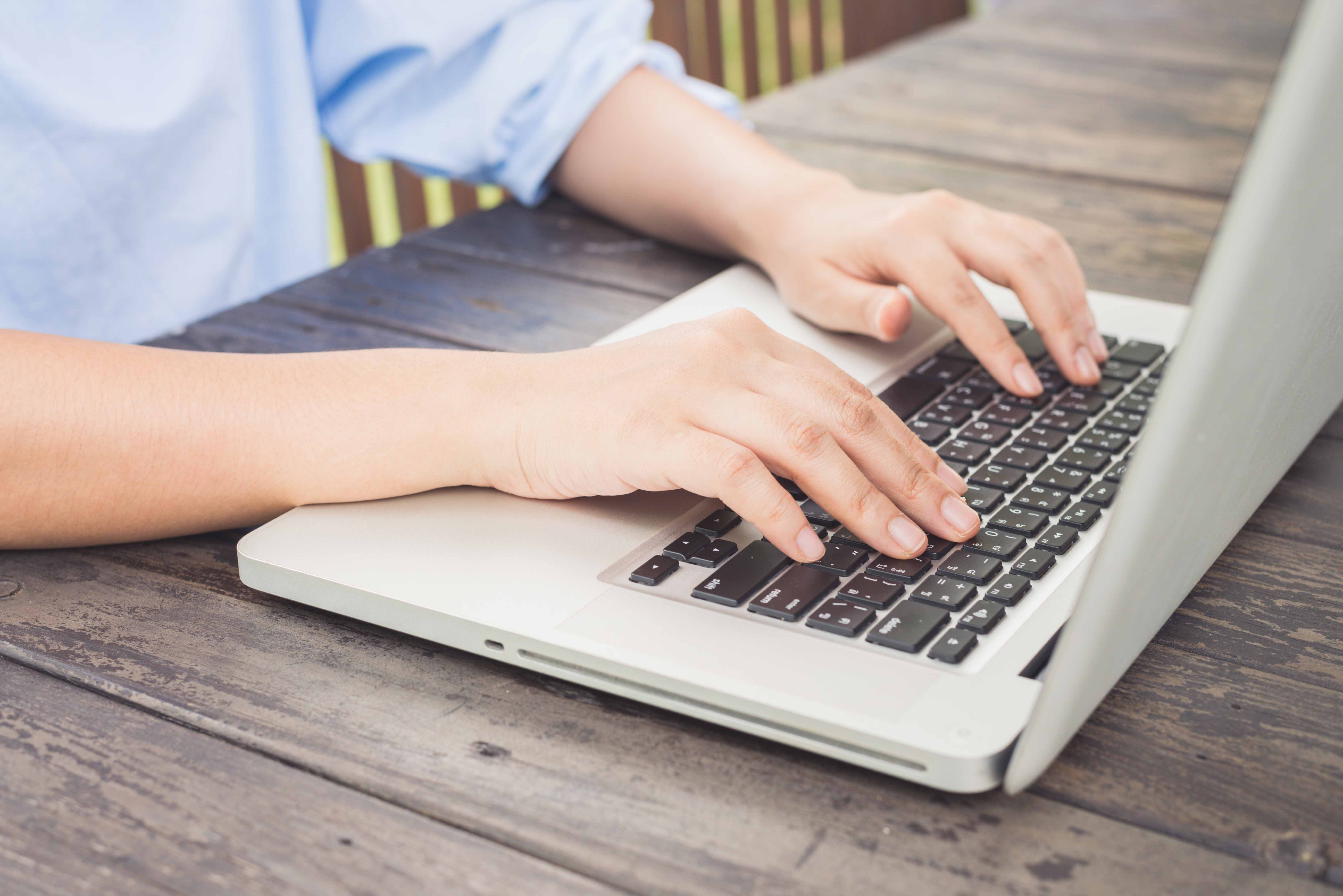 person typing laptop